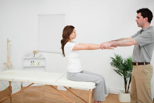 Manual stretching being made by a doctor in a medical room