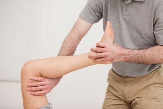 Leg of a patient being stretched in a room