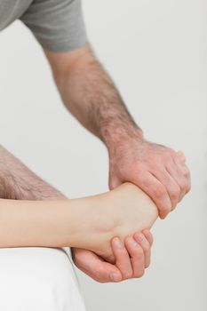 Ball of a foot being held by a physiotherapist in a room