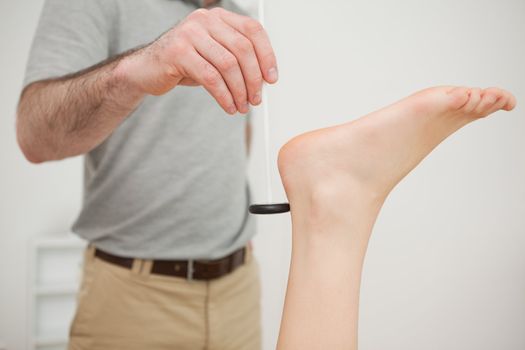 Reflex hammer being held by a doctor in a medical room