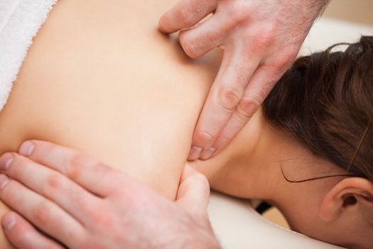 Doctor pressing the shoulder of his patient in a room