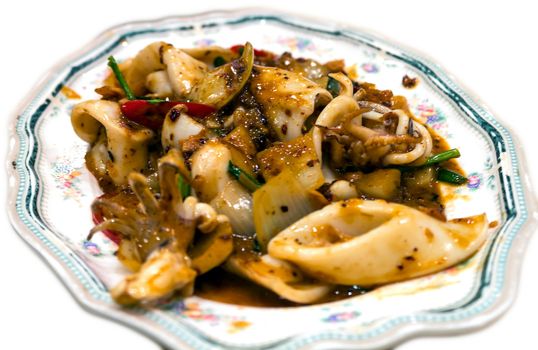 Isolated stir fried squid with salted egg yolk, thai fusion food style