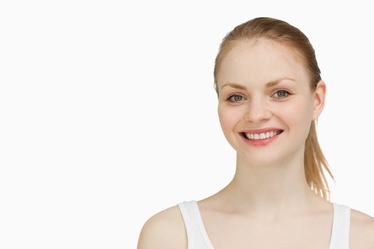 Smiling blonde-haired woman against white background