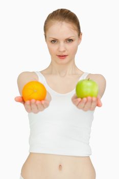 Woman presenting fruits against white background