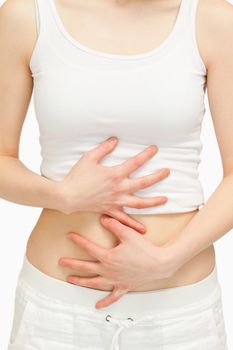 Woman touching her belly against white background