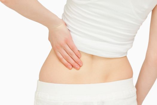 Close up of a woman massaging her back against white background