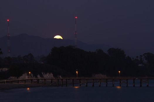 Full moon rise over Goleta Beach Park in California