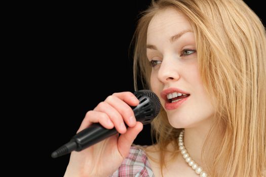 Young woman singing against white background