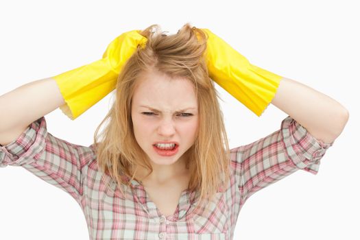 Woman pulling her hair against white background