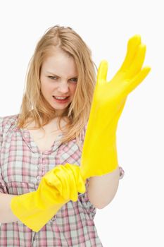 furious woman wearing cleaning gloves against white background