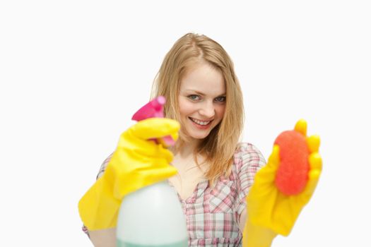 Woman holding cleaning agents against white background