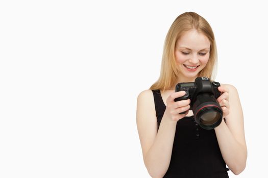 Cheerful woman looking at her camera against white background