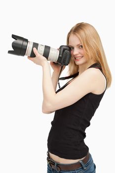 Joyful woman holding a SLR camera against white background