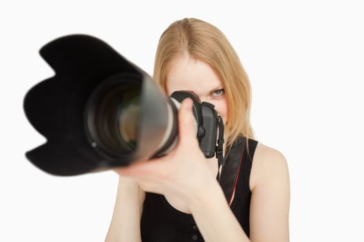 Woman using her camera against white background
