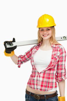 Cheerful woman holding a spirit level