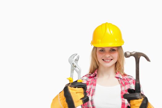 Woman smiling while wearing a safety helmet against white background