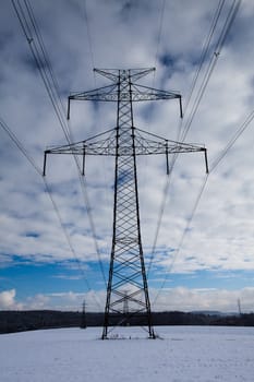 Transmission towers on the field in winter