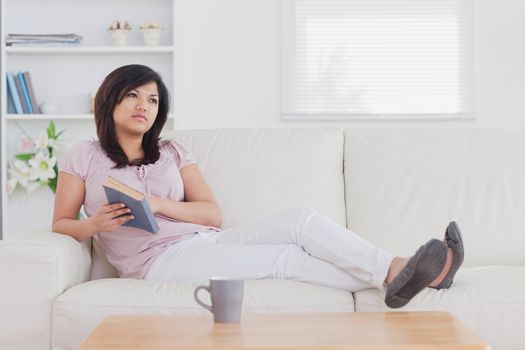 Woman relaxing on a couch in the living room