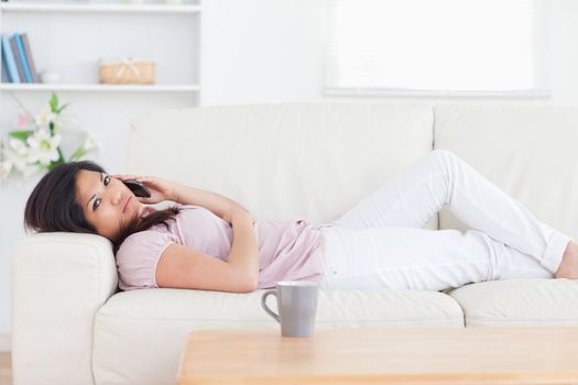 Woman resting on a couch in a living room