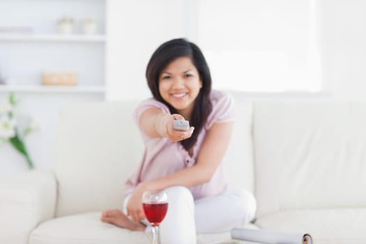 Woman holding a remote while sitting in a living room