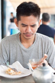 asian man enjoy eating breakfast