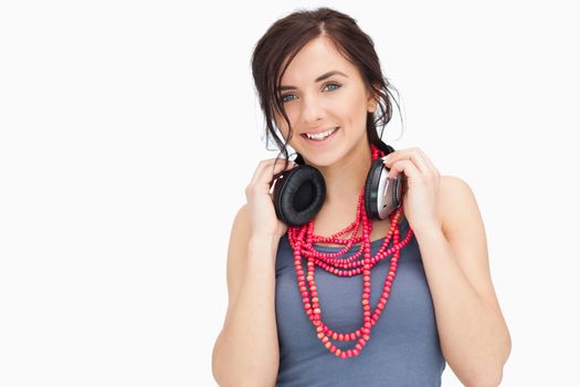 Young woman with headphones against white background