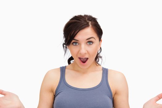 Surprised beautiful student against white background
