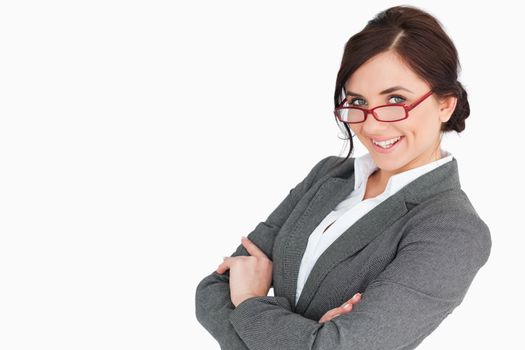 Attractive secretary with arms folded against white background