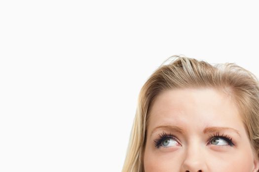 Blonde woman looking towards the side against a white background
