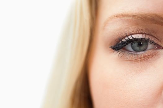 Blonde woman staring at the camera against a white background