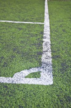 corner line of artificial grass indoor football field