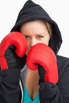 Pretty woman boxing against white background