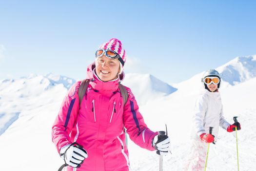 Happy skiers. Smiling woman with her daughter, Zellertal, Austria
