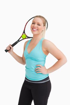 Woman holding a racquet behind her head against white background