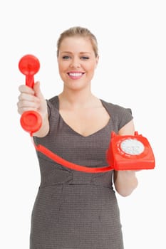 Woman showing a phone against white background