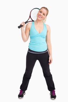 Woman standing with a tennis racket against white background