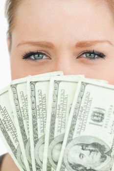 Pretty woman with dollars banknotes against white background