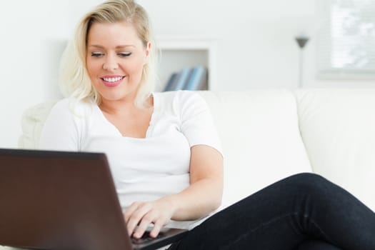 Casual woman using a laptop in a living room