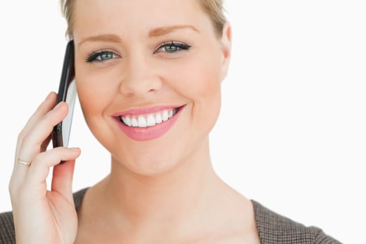 Woman calling with a smartphone against white background
