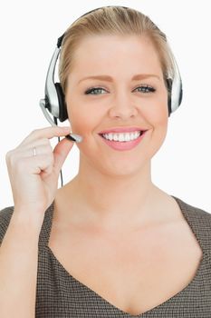 Smiling woman working in a call center against white background
