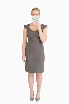 Businesswoman showing banknotes against white background