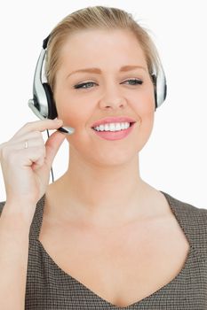 Pretty woman working in a call center against white background