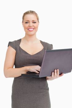 Woman holdind a laptop against white background