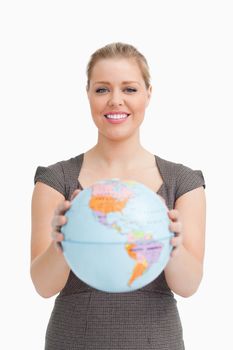 Woman holding a globe against white background