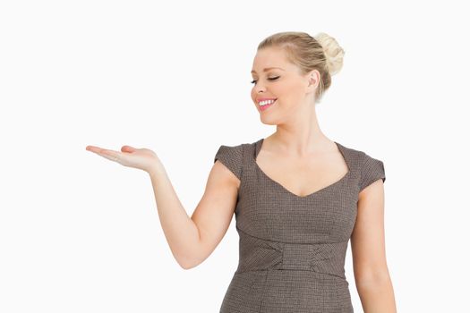 Woman gesturing with her hand against white background