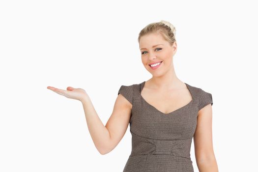 Woman presenting something with her hand against white background