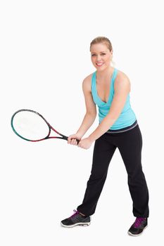 Woman holding a racquet with her two hands against white background