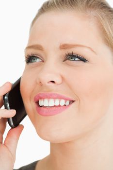 Close up of a pretty woman calling against white background
