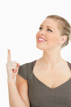 Woman smiling showing something against white background