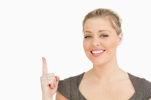 Woman smiling pointing something against white background